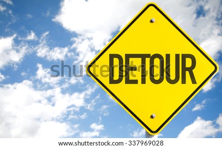 Detour sign with sky background