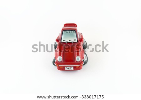Small red car from front money-box on white