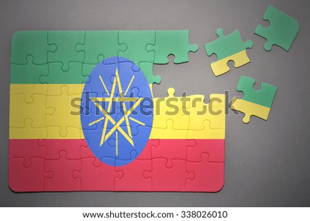 broken puzzle with the national flag of ethiopia on a gray background