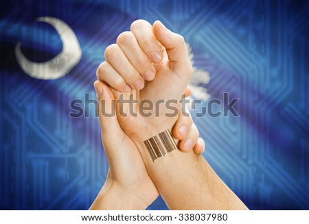 Barcode ID number tattoo on wrist and USA states flag on background - South Carolina