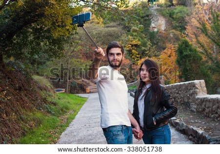young couple in park doing selfie
