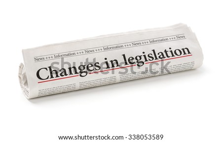 Rolled newspaper with the headline Changes in legislation Royalty-Free Stock Photo #338053589