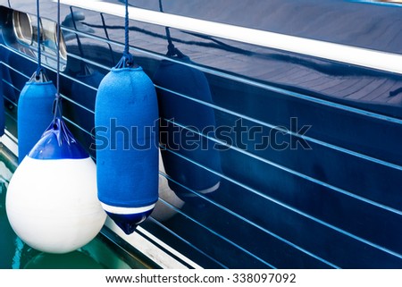 blue fenders on a boat Royalty-Free Stock Photo #338097092