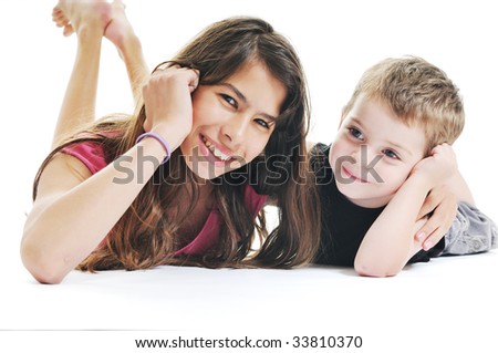 happy kids boy and girl lie on floor and play or kiss