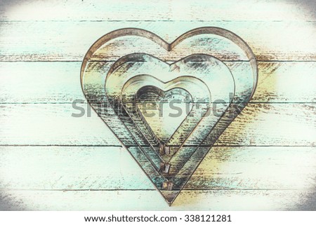 Heart cookie cutters on wooden background,soft focus,vintage filter,valentine's day concept