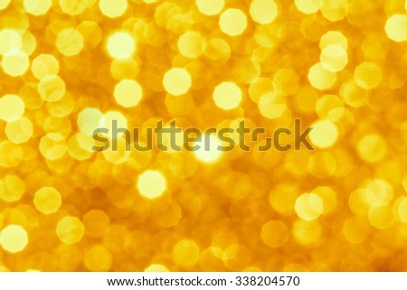 Gold and yellow Christmas Glittering background. Holiday abstract texture Festive background with defocused Golden bokeh