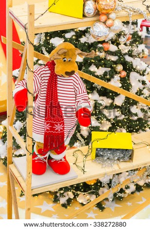 Reindeer preparing Christmas tree lights and gifts
