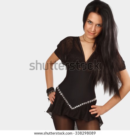 Young beautiful girl in a black dress , with long black hair , dress for dancing , photos made in the studio
