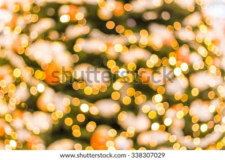 Gold Christmas background of de-focused lights with decorated tree
