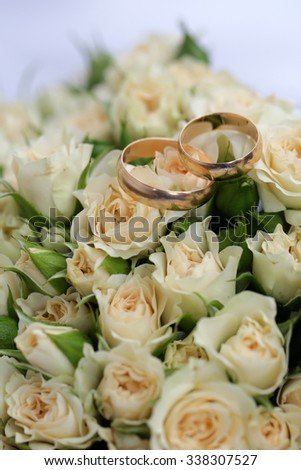 Closeup view of one beautiful fresh bright white yellow big wedding bouquet of rose flowers, vertical picture