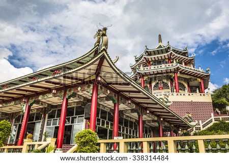 Pagoda and dragon sculpture of the Taoist Temple in Cebu, Philippines. Royalty-Free Stock Photo #338314484