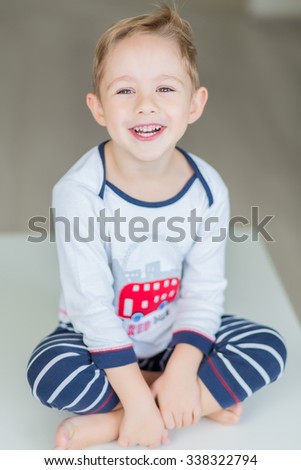 a happy little boy in pajamas 