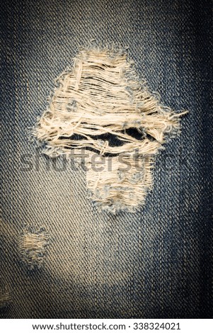 Vintage  jeans torn denim texture.