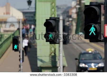 Three green traffic lights in a row