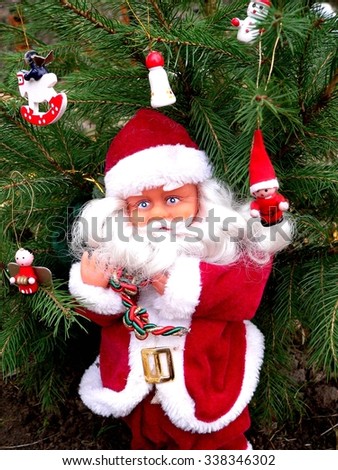 Santa Claus.Santa Claus standing at a live spruce with decorations