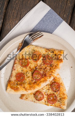 Italian pizza served on wooden table, close-up.