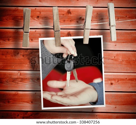 Photo hanging from line against wooden background