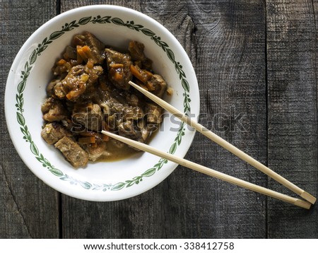 Pork Stew with Spicery in vintaje bowl on wooden weathering background