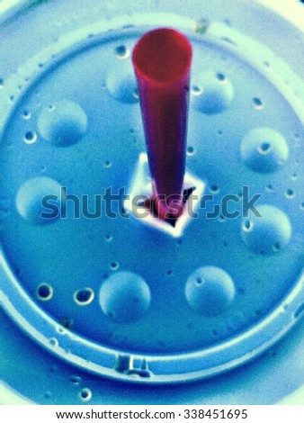 Looking down at the top of a straw and lid of a fountain drink