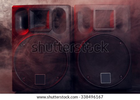 Big black loudspeakers in a smoke, close up