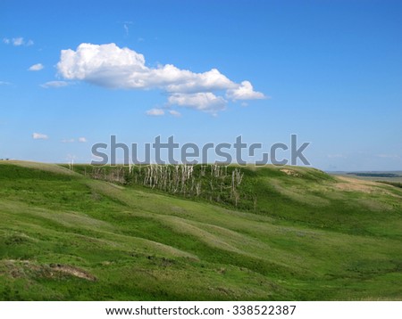 Steppe hill slopes against a blue sky 