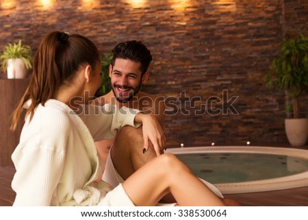 Portrait of an attractive young couple relaxing in a jacuzzi.
