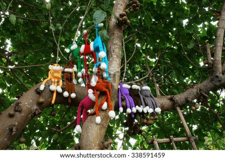 Amazing scene with group of knitted monkey climb tree, 2016 is year of the monkey, monkey symbol in colorful yarn to happy new year