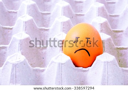  brown eggs face crying arranged in carton