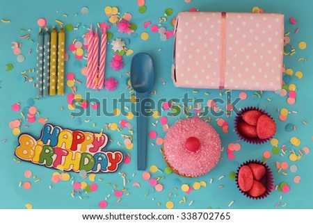 Birthday party set consist of cupcake, gift box and candles - happy birthday card on blue background
