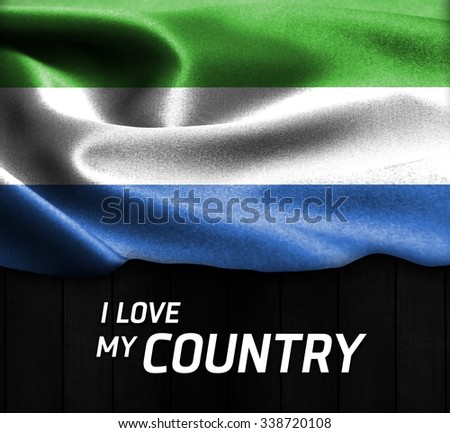 Sierra Leone waving flag with Text I Love My Country on wood texture background