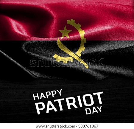 Happy Patriot Day Angola  flag on wood Texture background