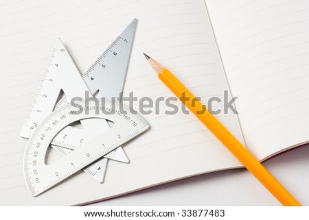 Measurement tools and pencil on a notebook