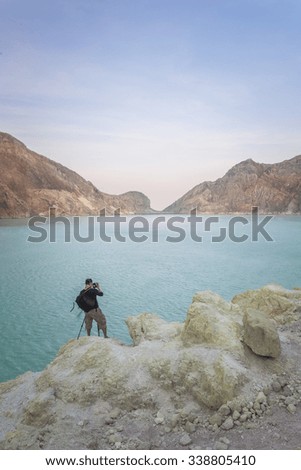 Photographer take a sea and mountain shot