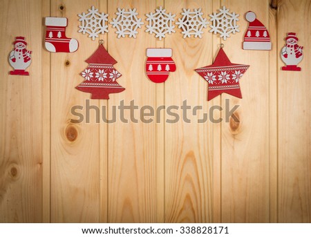 Wooden Christmas figurines snowmen snowflakes Christmas tree hat and stockings on a natural wooden background.