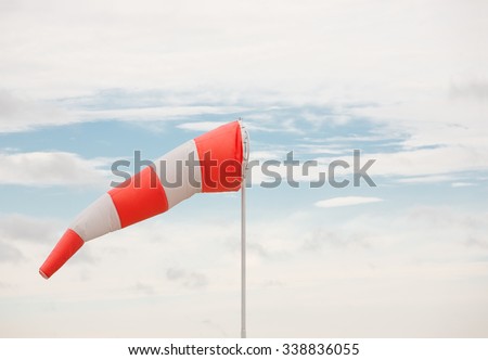 Airport windsock and sky.  Royalty-Free Stock Photo #338836055