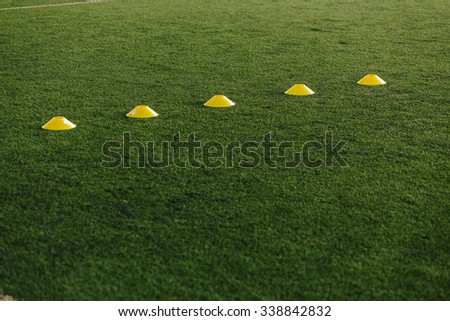 orange and yellow cones in football field