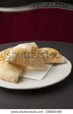pizza bread with sussame on white plate