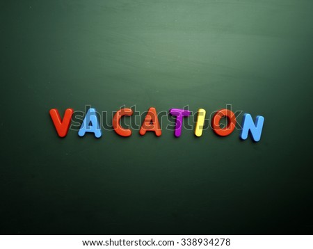 vacation concept in colorful letters isolated on blank blackboard