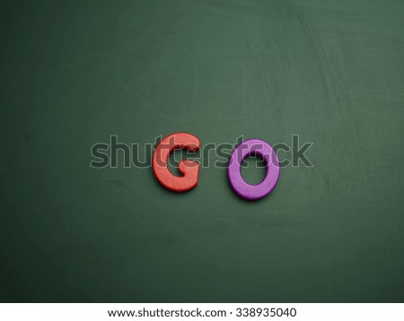 go concept in colorful letters isolated on blank blackboard