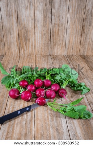 bunch of fresh radishes in an old wooden table
