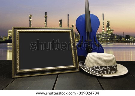 Vintage photo frame on wooden table over cityscape at twilight time background