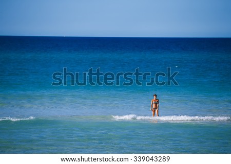 Russian girl swimming in atlantic ocean and paradise beach in Cuba