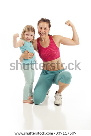 Healthy fit mom and child flexing on white studio background Royalty-Free Stock Photo #339117509