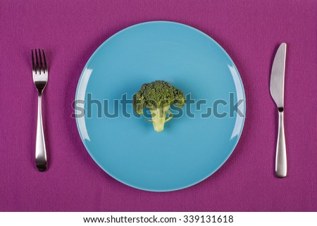 stock image of broccoli on blue plate. diet concept