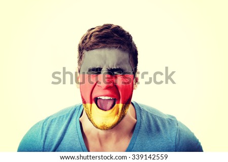 Screaming man with Germany flag painted on face.