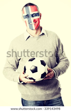 Mature man with Norway flag painted on face.