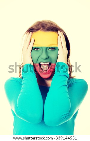 Woman with Lithuania flag painted on face.