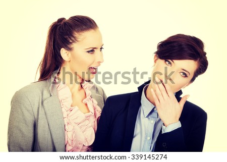 Businesswoman shouting on her yawning partner.