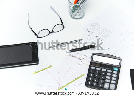 Photo of the Architectural plans and projects, pencils, rulers, compass, calculator, tablet, glasses and other tools