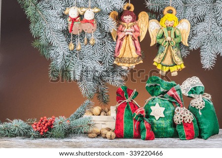 Christmas tree decorations. Colorful gift bags on a colored background
